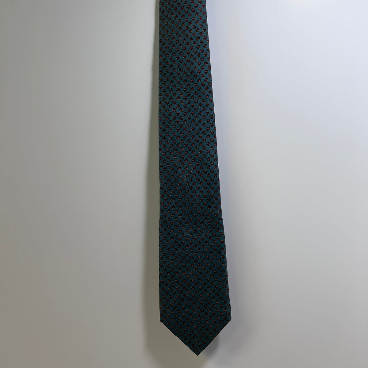 Black patterned tie on a light gray background