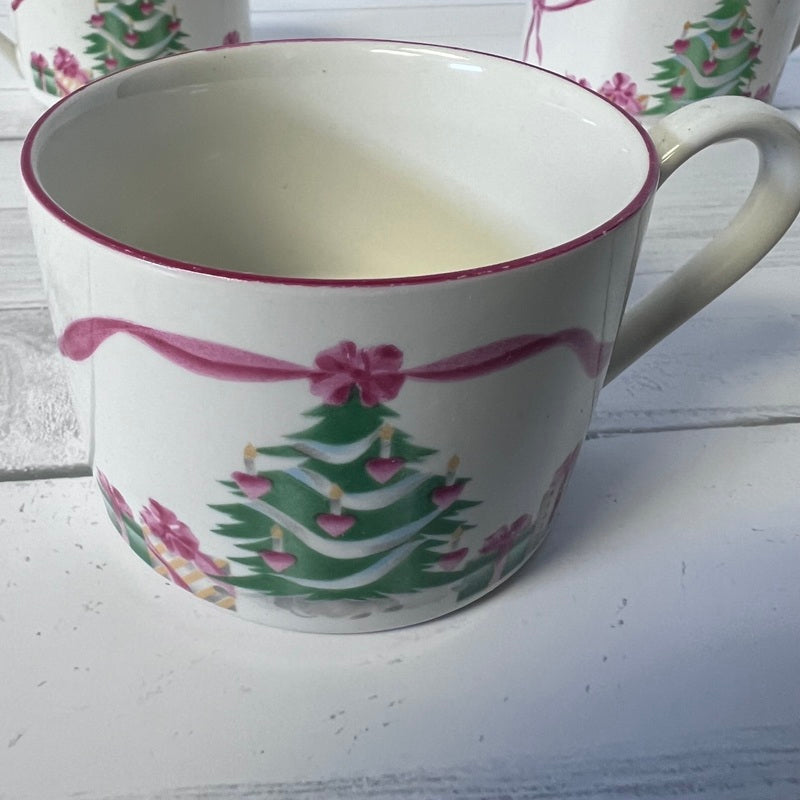 Mug with Christmas tree and bow design on a white surface
