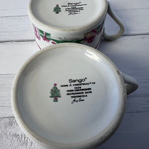 Two ceramic mugs with 'Sango' branding on a wooden surface