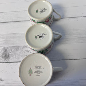Three ceramic mugs with 'Sango' branding on a wooden surface