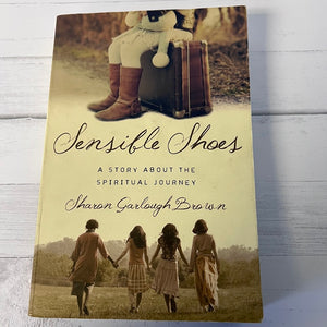 Book cover of 'Sensible Shoes' by Sharon Garlough Brown on a wooden surface