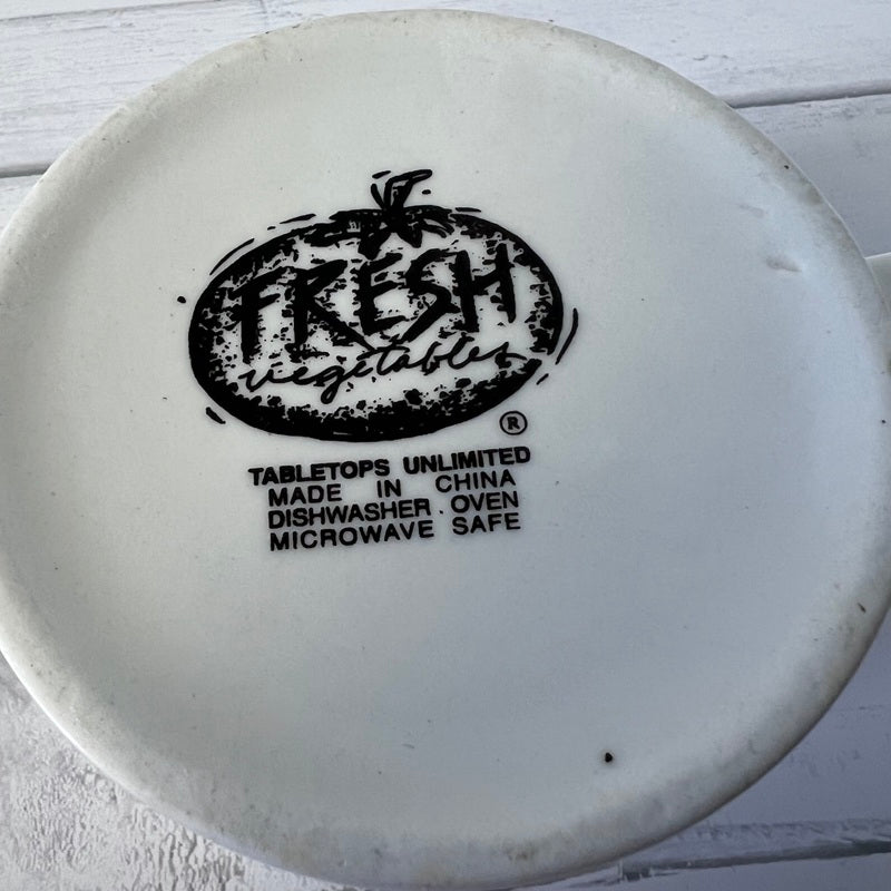 White plate with 'Fresh Vegetables' branding and safety information on a light wooden surface.