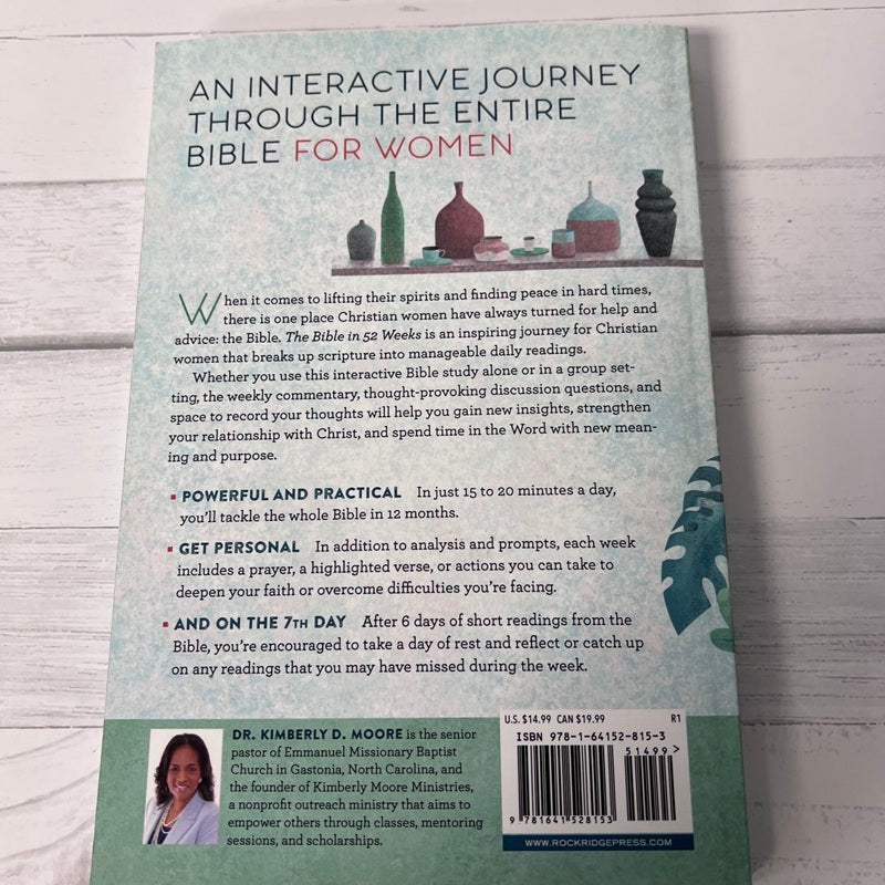 Back cover of a book titled 'An Interactive Journey Through the Entire Bible for Women' on a wooden surface.