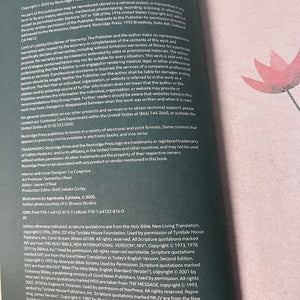 Back cover of a book with text and a pink flower design on a light background