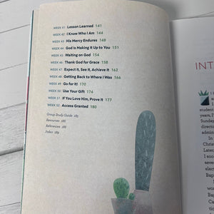Open book with a table of contents on a wooden surface