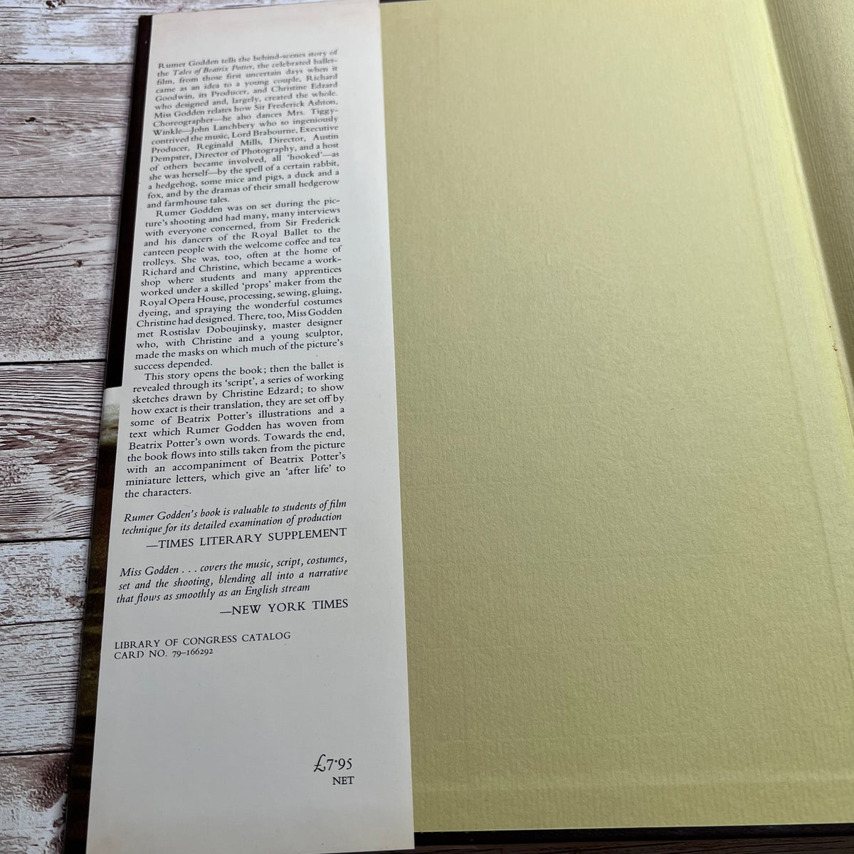 A printed book review page from The Times Literary Supplement, dated 2010, placed on top of a light beige book or book block. The page features black text on a white background with publisher and review details.