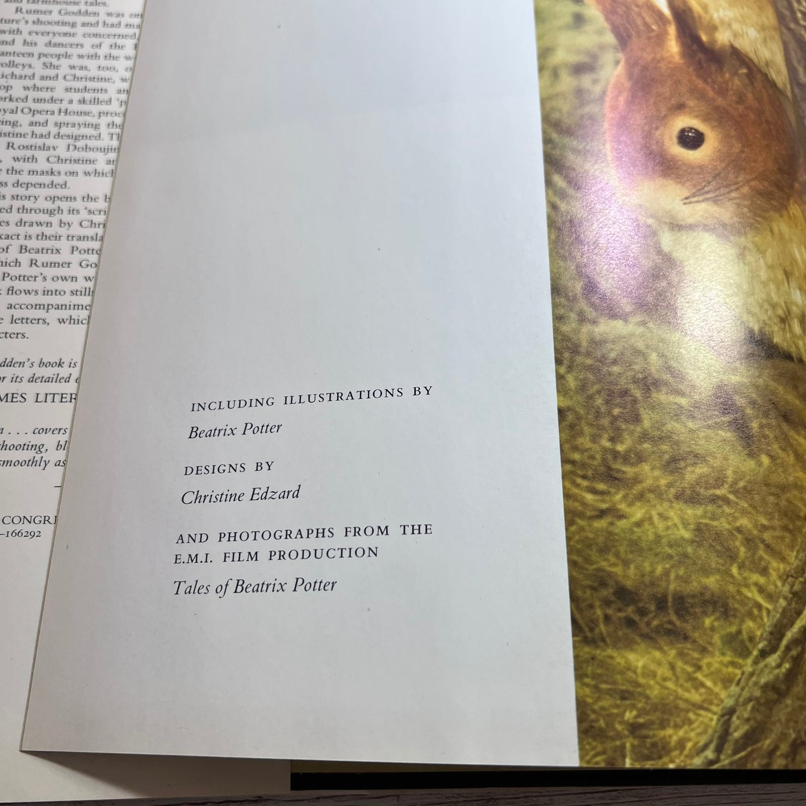 A close-up of an open book showing printed text on the left page and a cover illustration on the right page, featuring a brown bird with a yellow beak against a dark background.