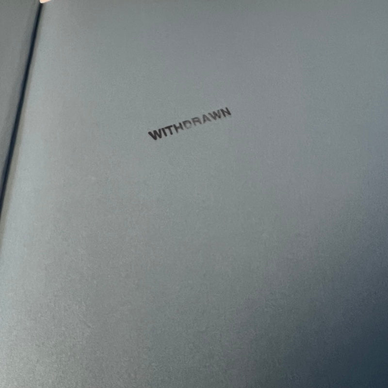 Gray book with 'WITHDRAWN' embossed on the cover