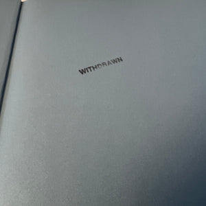 Gray book with 'WITHDRAWN' embossed on the cover