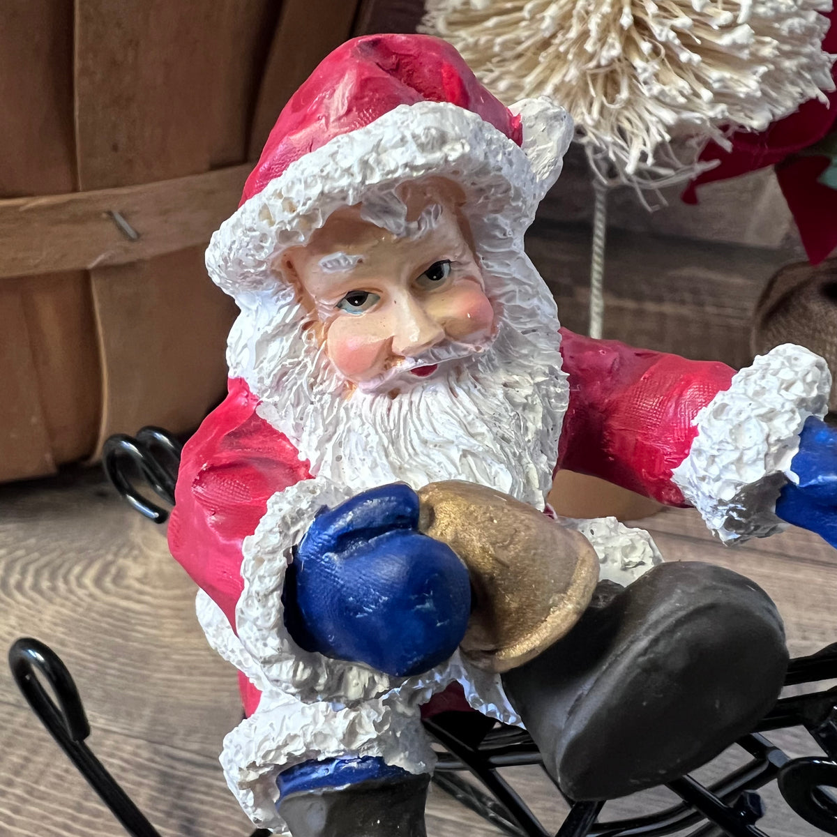 Vintage-style Santa Claus figurine with boxing gloves and a bell.