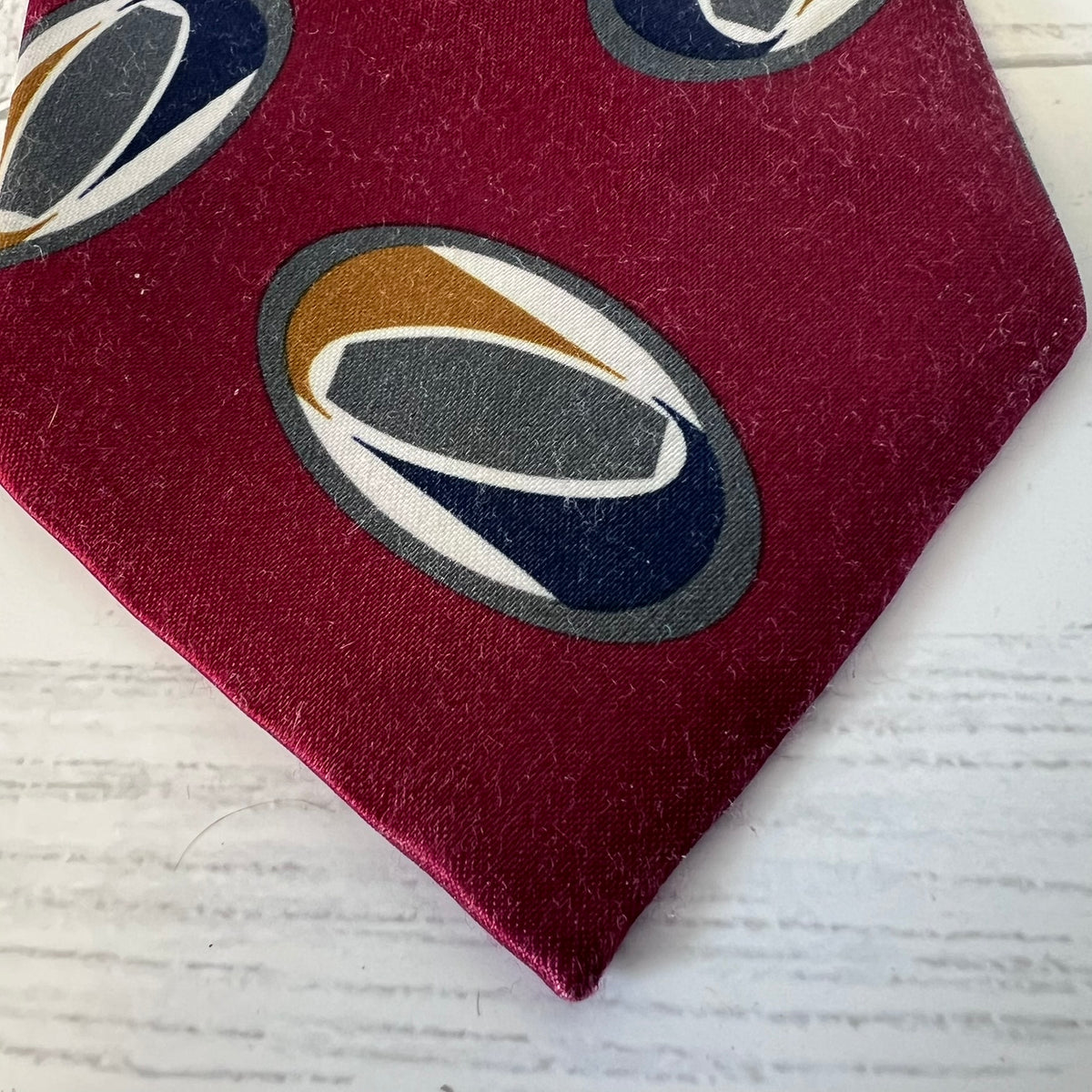 Red fabric with geometric pattern on a white wooden surface