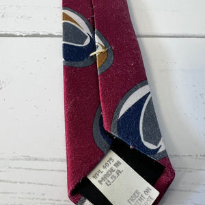 Maroon tie with abstract pattern on a white textured surface