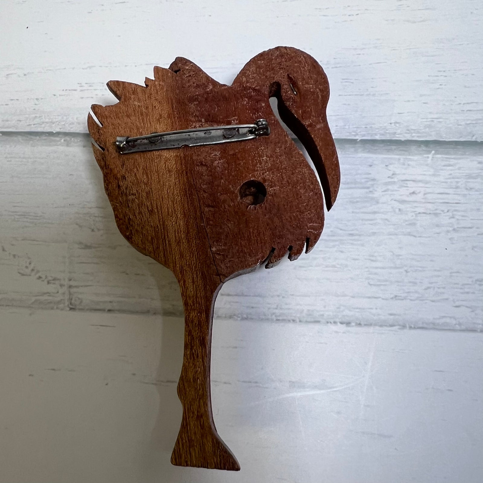 Vintage hand-carved wooden flamingo brooch dating to the 1940s