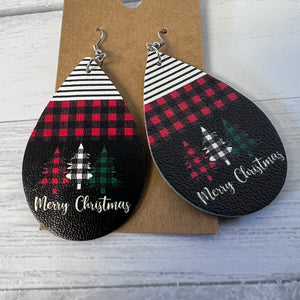 Teardrop-shaped earrings with Christmas designs on a cardboard backing.