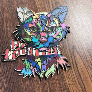 Colorful cat-shaped object on a wooden surface