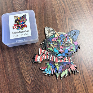 Colorful cat-shaped jigsaw puzzle piece on a wooden surface with packaging.