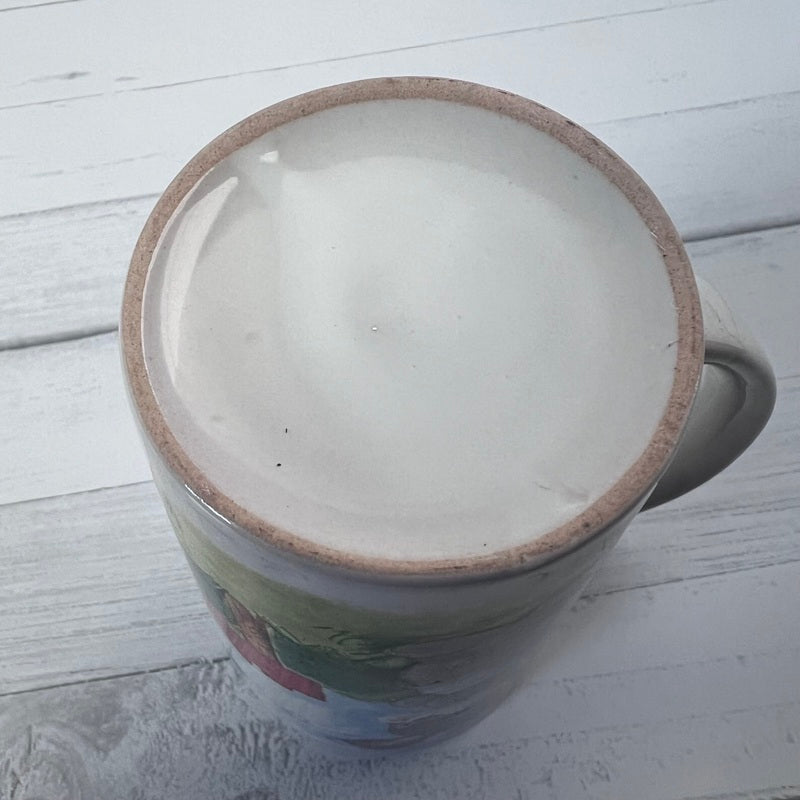 Ceramic mug with a brown rim on a light wooden surface