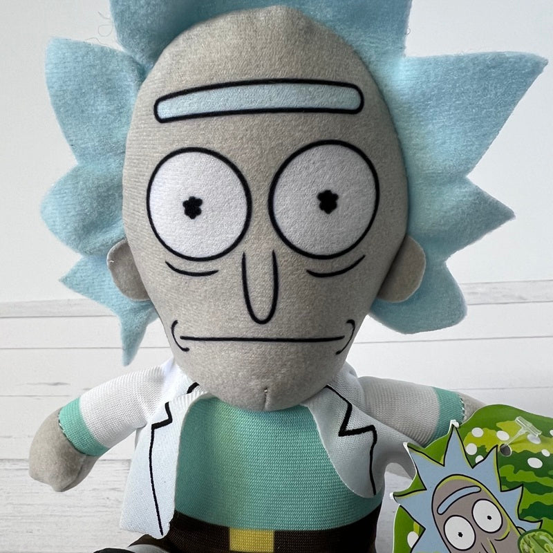 Plush toy resembling a character with light blue spiky hair and a green shirt on a white background