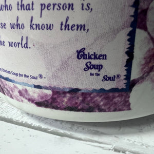 Close-up of a book titled 'Chicken Soup for the Soul' with text on a purple and white background.
