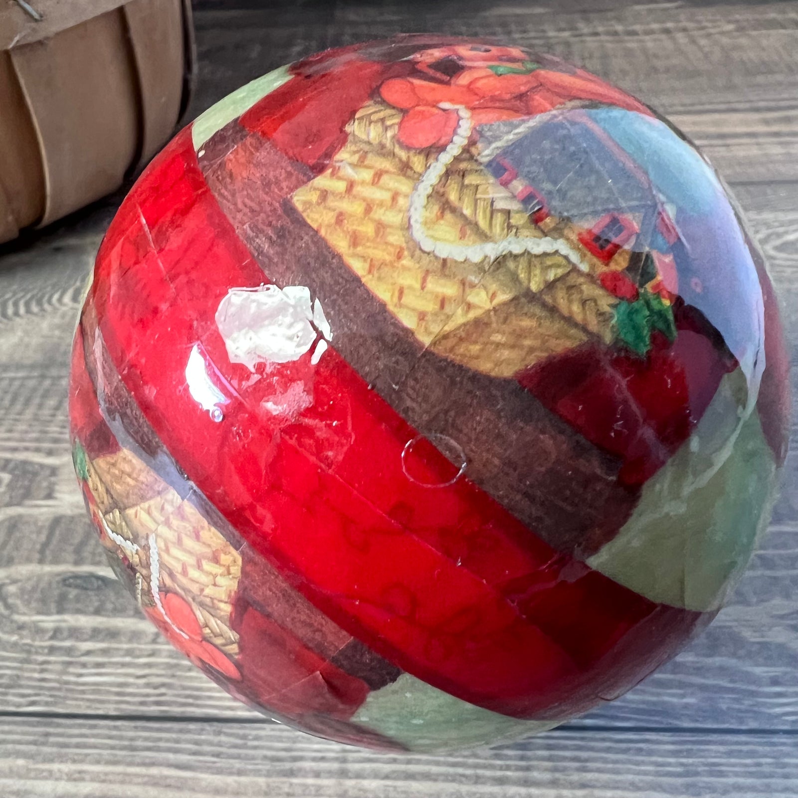 Decorative ball with a woven basket design on a wooden surface