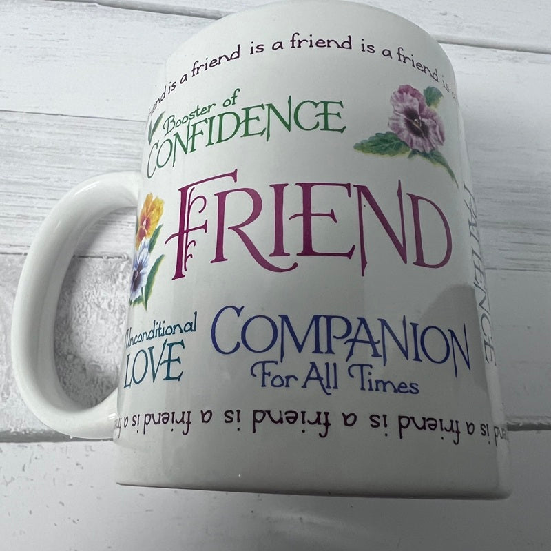 White mug with motivational text and floral designs on a light wooden background