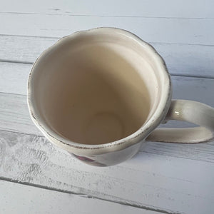 White ceramic mug on a light wooden surface