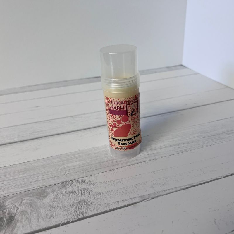 Bottle of peppermint foot lotion on a wooden surface