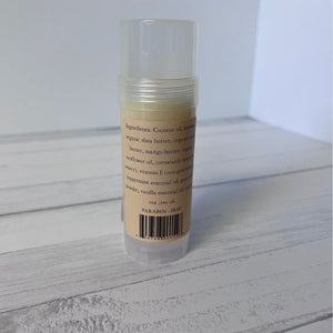 Foot Balm stick with label on a wooden surface