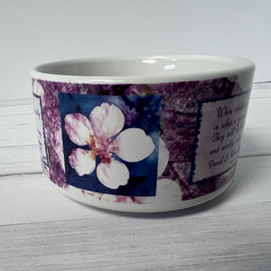 Ceramic bowl with floral design and text on a white background