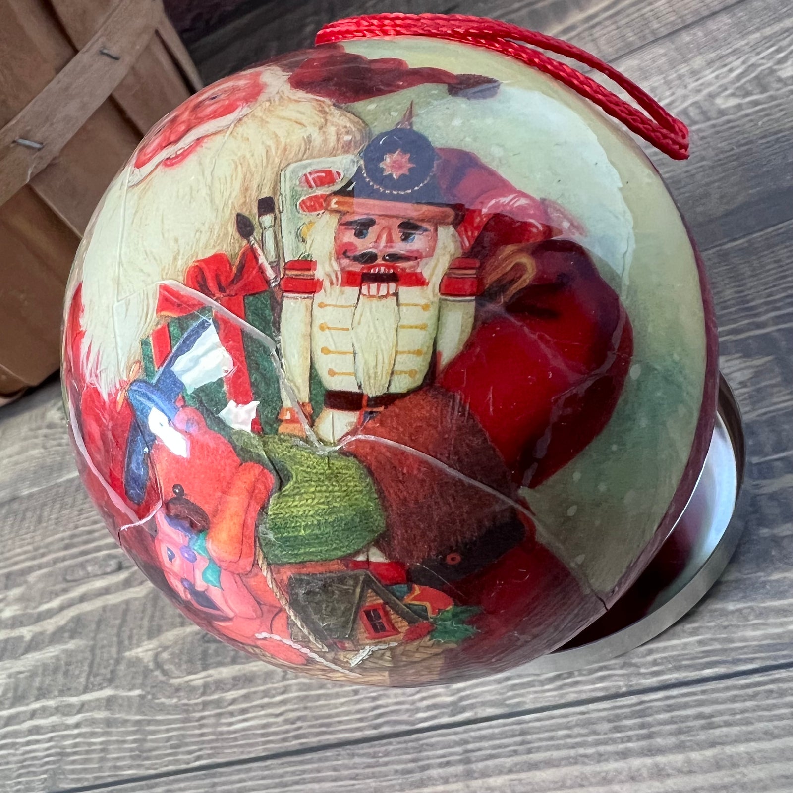 Decorative ball with a nutcracker design on a wooden surface