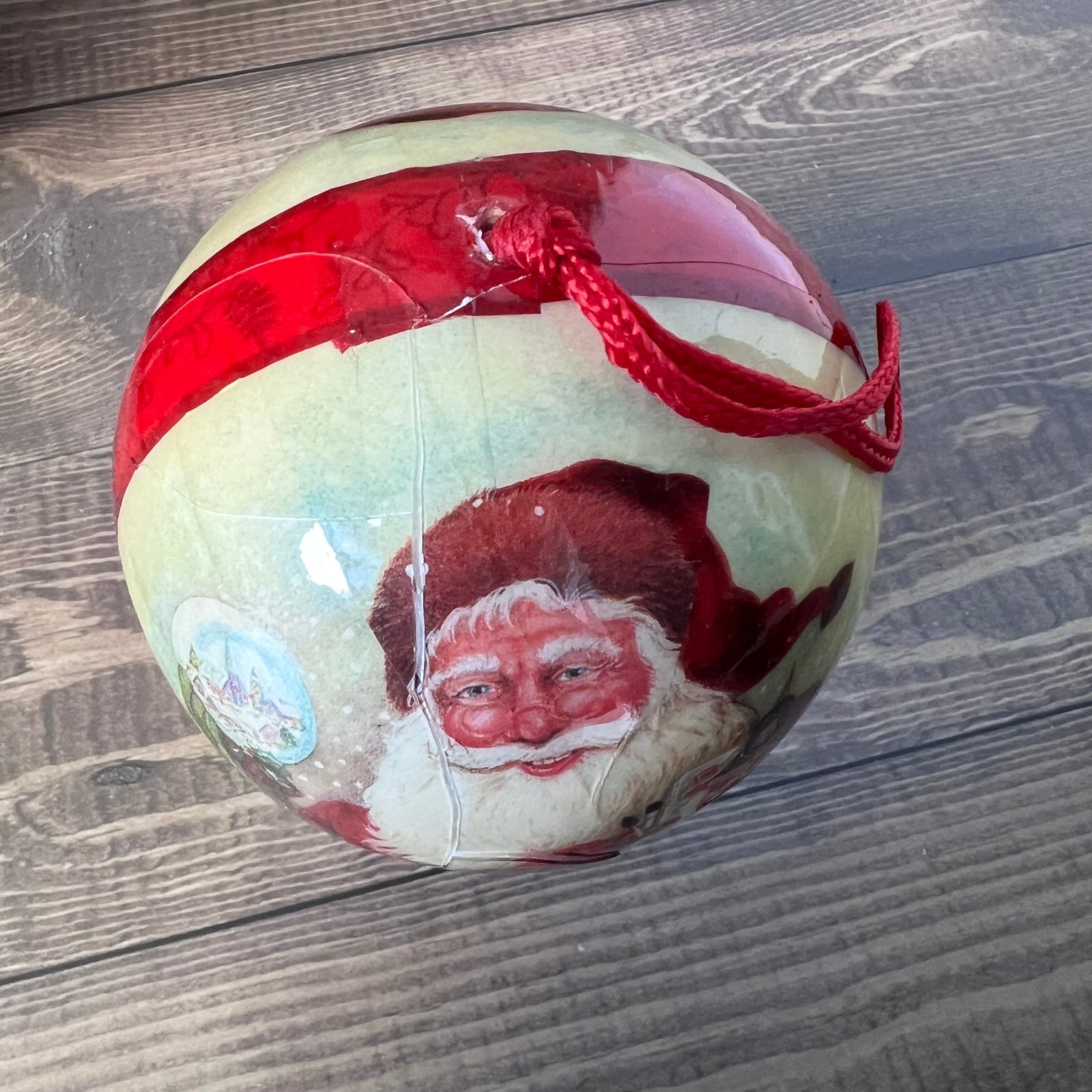 Christmas ornament with Santa Claus design on a wooden surface