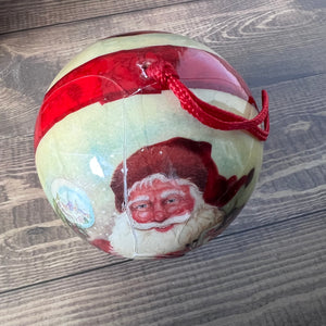 Christmas ornament with Santa Claus design on a wooden surface