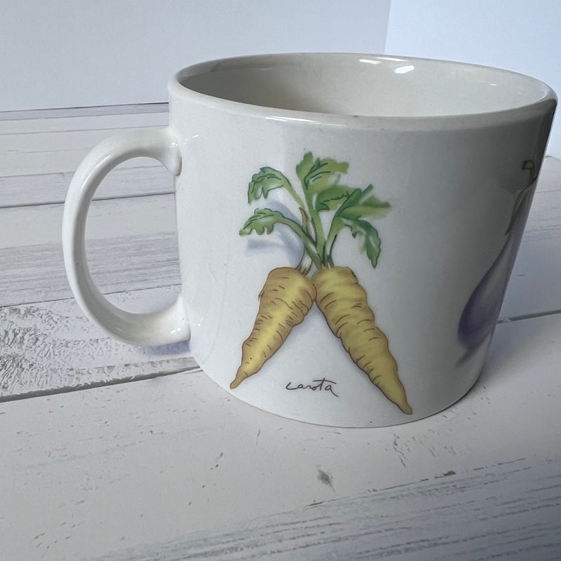 White mug with carrot design on a wooden surface