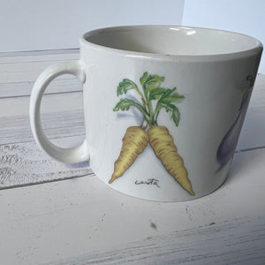 White mug with carrot design on a wooden surface