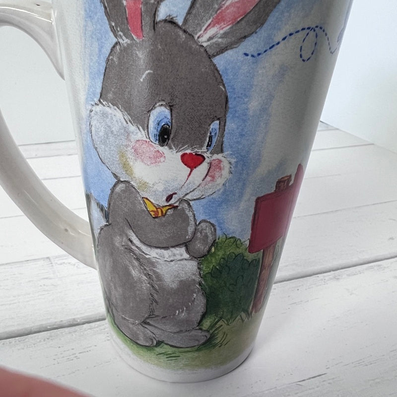 Mug with a cartoon rabbit design on a white wooden surface