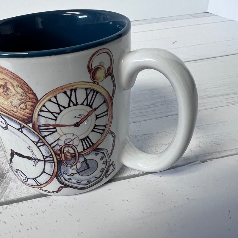 White mug with clock design on a white wooden surface