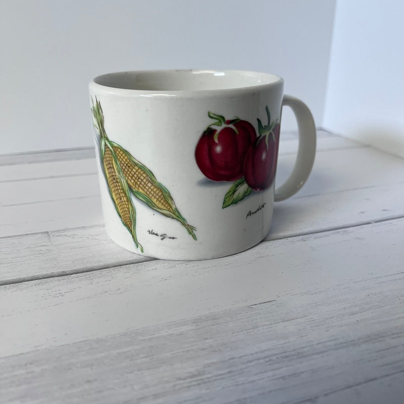 Mug with fruit design on a white wooden surface
