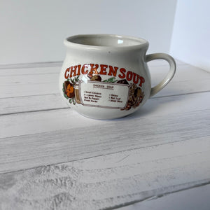 Mug with 'Chicken Soup' text on a wooden surface