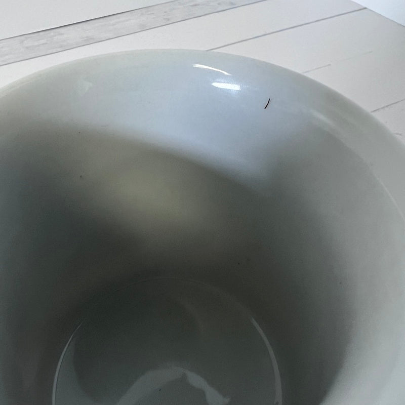 Close-up of a white ceramic bowl on a tiled floor